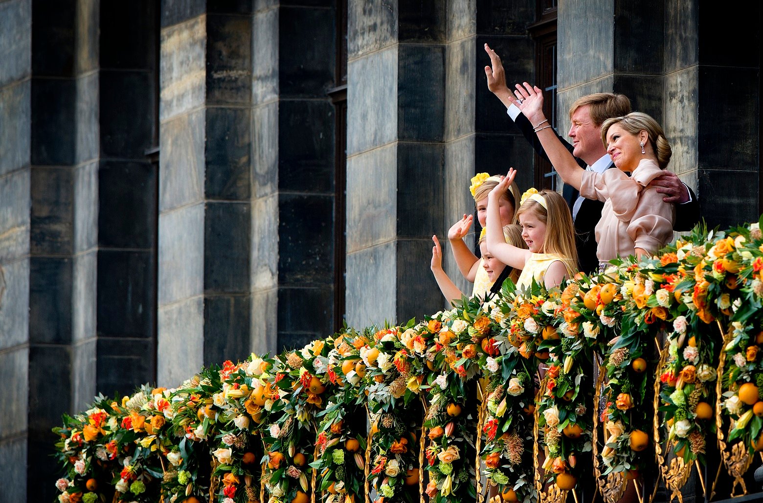Dutch King Willem-Alexander and Queen Maxima appear on the balcony of the Royal Palace with their children, from left: Catharina-Amalia, Ariane, and Alexia in Amsterdam, The Netherlands, Tuesday April 30, 2013. Around a million people are expected to descend on the Dutch capital for a huge street party to celebrate the first new Dutch monarch in 33 years. (AP Photo/Robin Utrecht, pool)